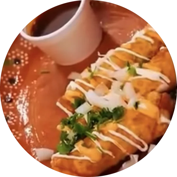 Rolled tacos with crema, onion and cilantro